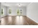 Open concept floor plan with hardwood floors and neutral paint with doors to the outside at 209 Broomgrove Way, Wake Forest, NC 27587