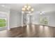 Spacious living room with hardwood floors, staircase, and patio access at 209 Broomgrove Way, Wake Forest, NC 27587