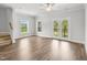View of the living room with hardwood floors and neutrally painted walls, with natural light coming in at 209 Broomgrove Way, Wake Forest, NC 27587