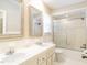 Bright bathroom features a double vanity and shower-tub combo at 223 Shadowbrook Dr, Burlington, NC 27215