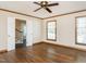 Bedroom with hardwood floors, neutral walls, and natural light from large windows at 223 Shadowbrook Dr, Burlington, NC 27215