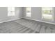 Spacious bedroom with neutral carpet, three windows, and ample natural light at 223 Shadowbrook Dr, Burlington, NC 27215