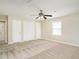Bright bedroom with two closets, neutral walls, carpet, and windows offering natural light at 223 Shadowbrook Dr, Burlington, NC 27215