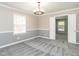 Comfortable bedroom featuring chair rail, decorative light, and new carpet at 223 Shadowbrook Dr, Burlington, NC 27215