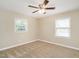 Bright bedroom features a ceiling fan and large windows at 223 Shadowbrook Dr, Burlington, NC 27215