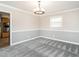 Dining room with chair rail, neutral carpet, and an open view of the kitchen at 223 Shadowbrook Dr, Burlington, NC 27215