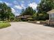 Spacious driveway with lush landscaping, leading to a backyard patio and beautifully maintained property at 223 Shadowbrook Dr, Burlington, NC 27215