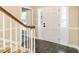 Welcoming entryway features slate floors, paneled door, and wooden staircase at 223 Shadowbrook Dr, Burlington, NC 27215