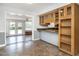 Open kitchen with tiled floors, wood cabinets and access to a bright sunroom at 223 Shadowbrook Dr, Burlington, NC 27215
