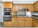 Spacious kitchen with stainless steel appliances, wood cabinets, and granite countertops at 223 Shadowbrook Dr, Burlington, NC 27215