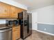 Bright kitchen featuring stainless steel refrigerator, microwave and wood cabinets at 223 Shadowbrook Dr, Burlington, NC 27215