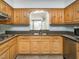 Traditional kitchen with wood cabinetry, granite countertops and stainless steel appliances at 223 Shadowbrook Dr, Burlington, NC 27215