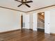 Spacious living room with hardwood floors, ceiling fan, and view of stairs, offering a bright and inviting atmosphere at 223 Shadowbrook Dr, Burlington, NC 27215