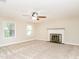 Inviting living room with fireplace, carpet, and ample natural light, creating a warm and welcoming space at 223 Shadowbrook Dr, Burlington, NC 27215