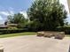 Secluded backyard patio featuring custom stone seating area and lush landscaping at 223 Shadowbrook Dr, Burlington, NC 27215
