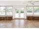 Bright sun room with tile floors, lots of windows, ceiling fan, and built in seating, offers an inviting atmosphere at 223 Shadowbrook Dr, Burlington, NC 27215