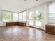 Sun room featuring tile floors, large windows, and built-in seating and storage, seamlessly blends indoor and outdoor living at 223 Shadowbrook Dr, Burlington, NC 27215