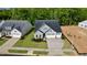 Aerial view showcasing a gray craftsman home with an attached garage and newly seeded lawn at 2313 Abbeyhill Dr # 3, Raleigh, NC 27610