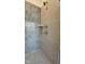 Modern shower with gray honeycomb accent tiles and a rain shower head fixture at 2313 Abbeyhill Dr # 3, Raleigh, NC 27610