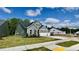 Gray two-story home with a three-car garage situated on a green lot at 2313 Abbeyhill Dr # 3, Raleigh, NC 27610