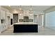 Open-concept kitchen with a large island, pendant lighting, and updated stainless appliances at 2313 Abbeyhill Dr # 3, Raleigh, NC 27610