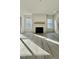 Bright living room with a white fireplace and mantel, light wood floors, and an abundance of natural light at 2313 Abbeyhill Dr # 3, Raleigh, NC 27610