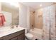 Bathroom featuring a vanity, toilet, and a tiled shower-tub combo with curtain at 2501 Impulsion Dr, New Hill, NC 27562