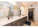 Bathroom featuring double sinks, spacious countertops, and a walk-in closet for ample storage at 2501 Impulsion Dr, New Hill, NC 27562