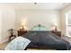 A bedroom featuring a large bed, side tables with lamps, and a relaxing atmosphere at 2501 Impulsion Dr, New Hill, NC 27562
