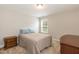 Bedroom with a beige bed, carpeted floors, and a bright window for natural light at 2501 Impulsion Dr, New Hill, NC 27562