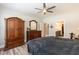 Bedroom featuring a wooden dresser, a ceiling fan, and an ensuite bathroom with neutral colors at 2501 Impulsion Dr, New Hill, NC 27562