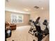 Bonus room featuring exercise equipment, a leather couch, and natural light from the window at 2501 Impulsion Dr, New Hill, NC 27562