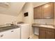 Laundry room with Maytag washer/dryer, granite counters, sink, and built-in storage at 2501 Impulsion Dr, New Hill, NC 27562
