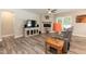 Cozy living room with fireplace, ceiling fan, and a large window for ample natural light at 2501 Impulsion Dr, New Hill, NC 27562