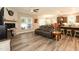 Open-concept living room with hardwood floors seamlessly connects to the kitchen, perfect for gatherings at 2501 Impulsion Dr, New Hill, NC 27562