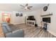 Spacious living room featuring wood floors, a fireplace, and an open layout for entertaining at 2501 Impulsion Dr, New Hill, NC 27562