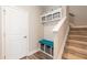 Convenient mudroom area with a bench, storage cubbies, and easy access to the stairs at 2501 Impulsion Dr, New Hill, NC 27562