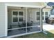 View of the screened-in back porch featuring an outdoor dining table with seating at 2501 Impulsion Dr, New Hill, NC 27562