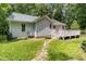 Backyard with a well-maintained lawn and a small deck attached to the house at 2805 Evans St, Durham, NC 27705