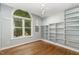 Bedroom featuring hardwood floors and a large window with built in shelving at 2805 Evans St, Durham, NC 27705