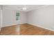 Bedroom featuring hardwood floors and a single window overlooking the outdoors at 2805 Evans St, Durham, NC 27705
