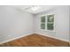 Bedroom featuring hardwood floors and a window overlooking the backyard at 2805 Evans St, Durham, NC 27705