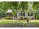 Inviting home exterior with a covered porch, well-manicured shrubs, and bright lawn at 2805 Evans St, Durham, NC 27705