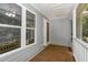 Enclosed back porch featuring wood-look floors, and multiple windows at 2805 Evans St, Durham, NC 27705