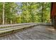 Expansive wood deck with built-in benches, perfect for entertaining or relaxing in a private, wooded setting at 307 Yowland Rd, Henderson, NC 27536