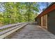 Expansive wood deck with built-in benches, perfect for entertaining or relaxing in a private, wooded setting at 307 Yowland Rd, Henderson, NC 27536
