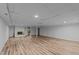 Large, updated basement features wood floors, a fireplace and recessed lighting at 307 Yowland Rd, Henderson, NC 27536