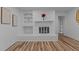 Cozy living room with fireplace and built-in shelves, featuring elegant flooring at 307 Yowland Rd, Henderson, NC 27536