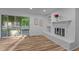Bright living room with hardwood floors, fireplace, and sliding doors to outdoor deck at 307 Yowland Rd, Henderson, NC 27536