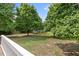 Expansive backyard view showing lush greenery and a pool, ideal for outdoor activities and relaxation at 3208 Wilbon Ridge Dr, Holly Springs, NC 27540